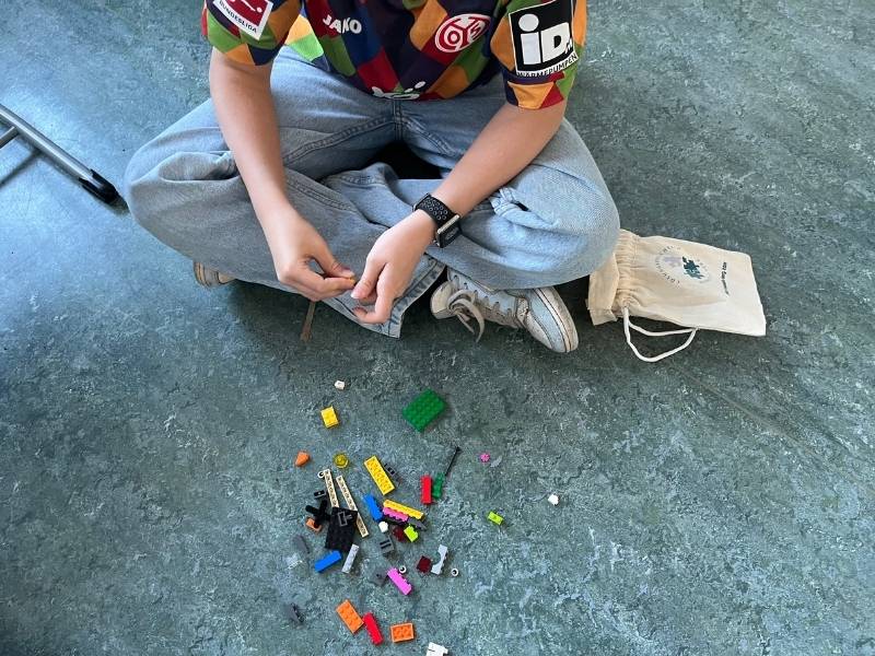 Baue deine Stärken - Resilienztraining in der 6. Klasse - Kind sitzt vor Lego®-Steinen